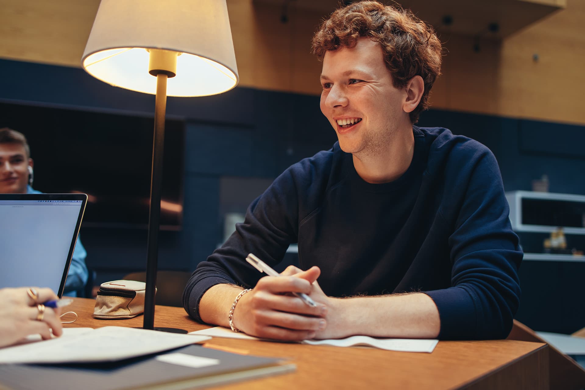 Cheerful male student studying in college library.